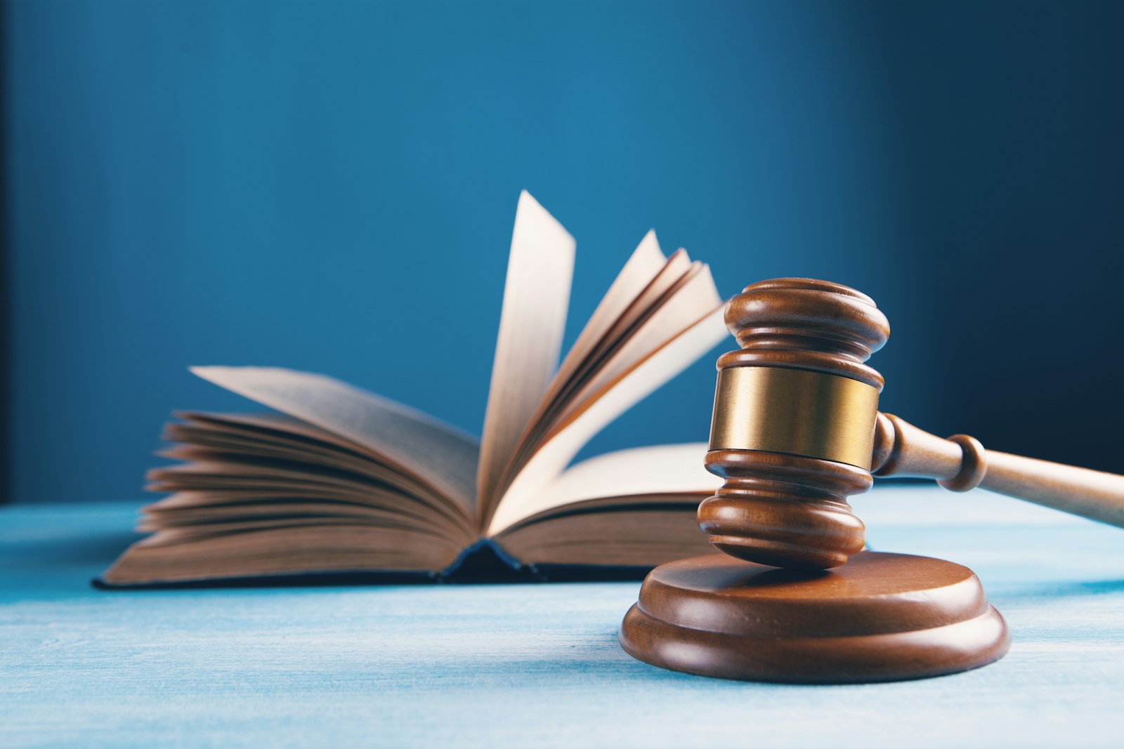 A judge's gavel resting beside an open book